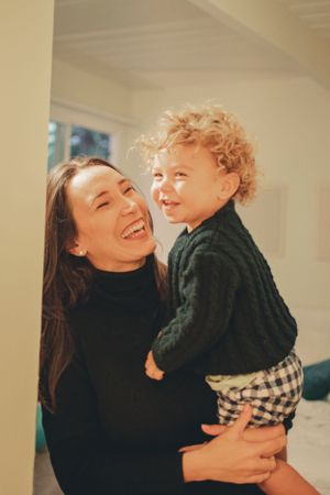 Candid indoor sequence capturing genuine loving interactions and laughter.