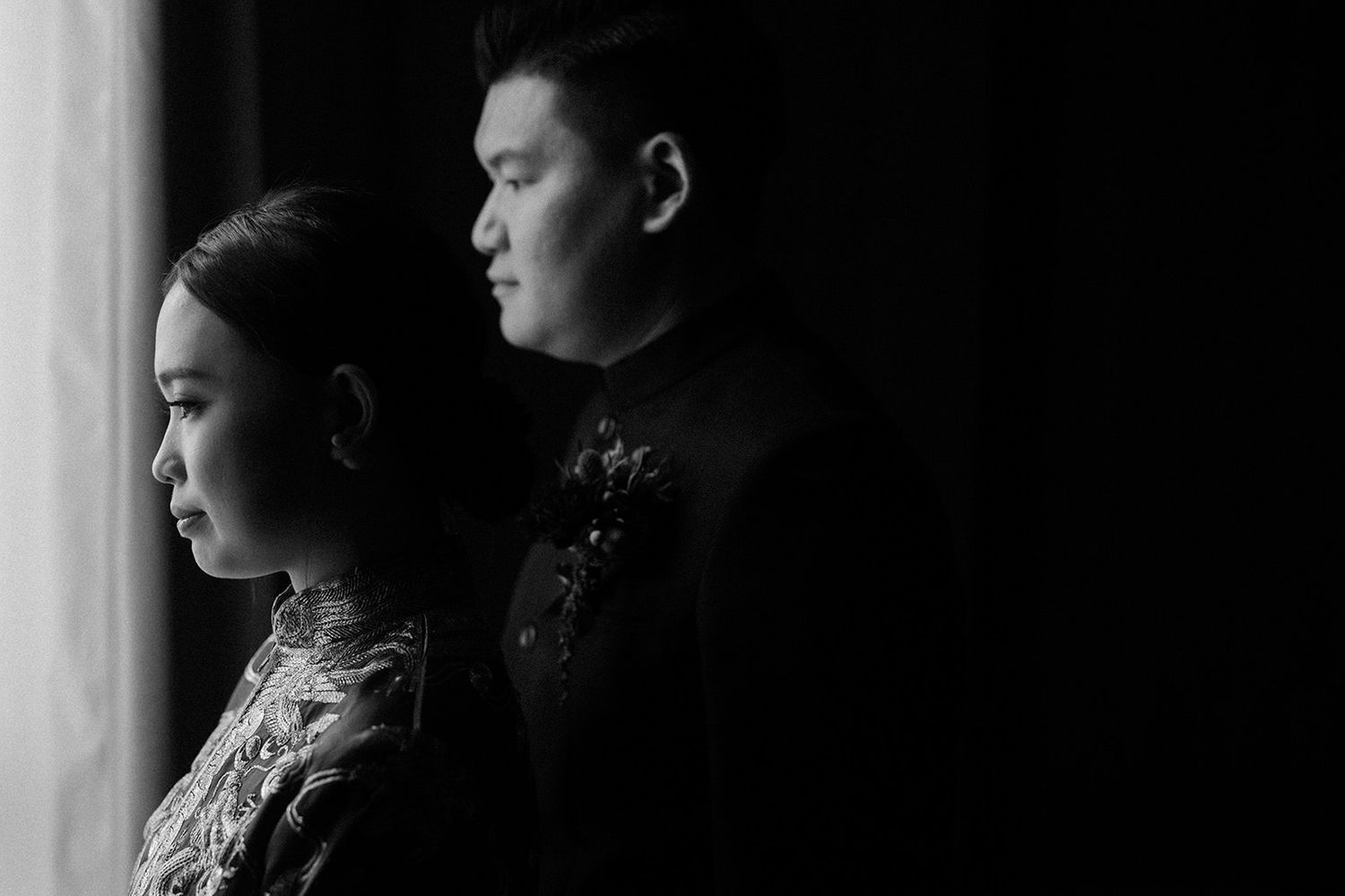 Chinese Husband and wife looking out of window