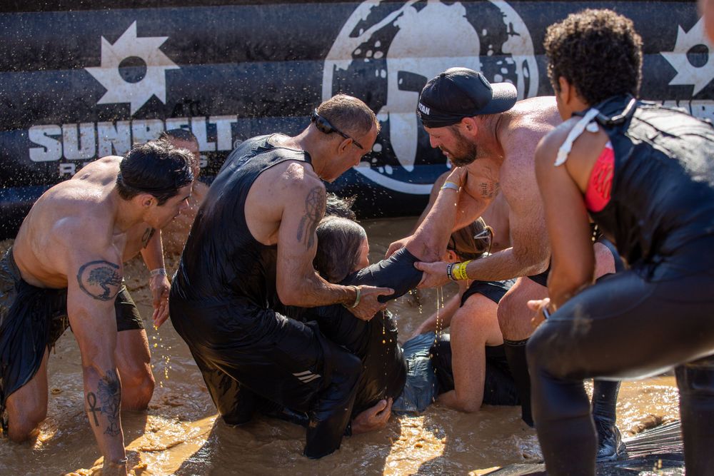 Participants gather to discuss strategy during a break in an outdoor endurance competition.