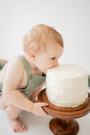 First Birthday. Close up shoot of a ONE year old taking a bite out of his smash cake. Wrightstown NJ Family Photographer