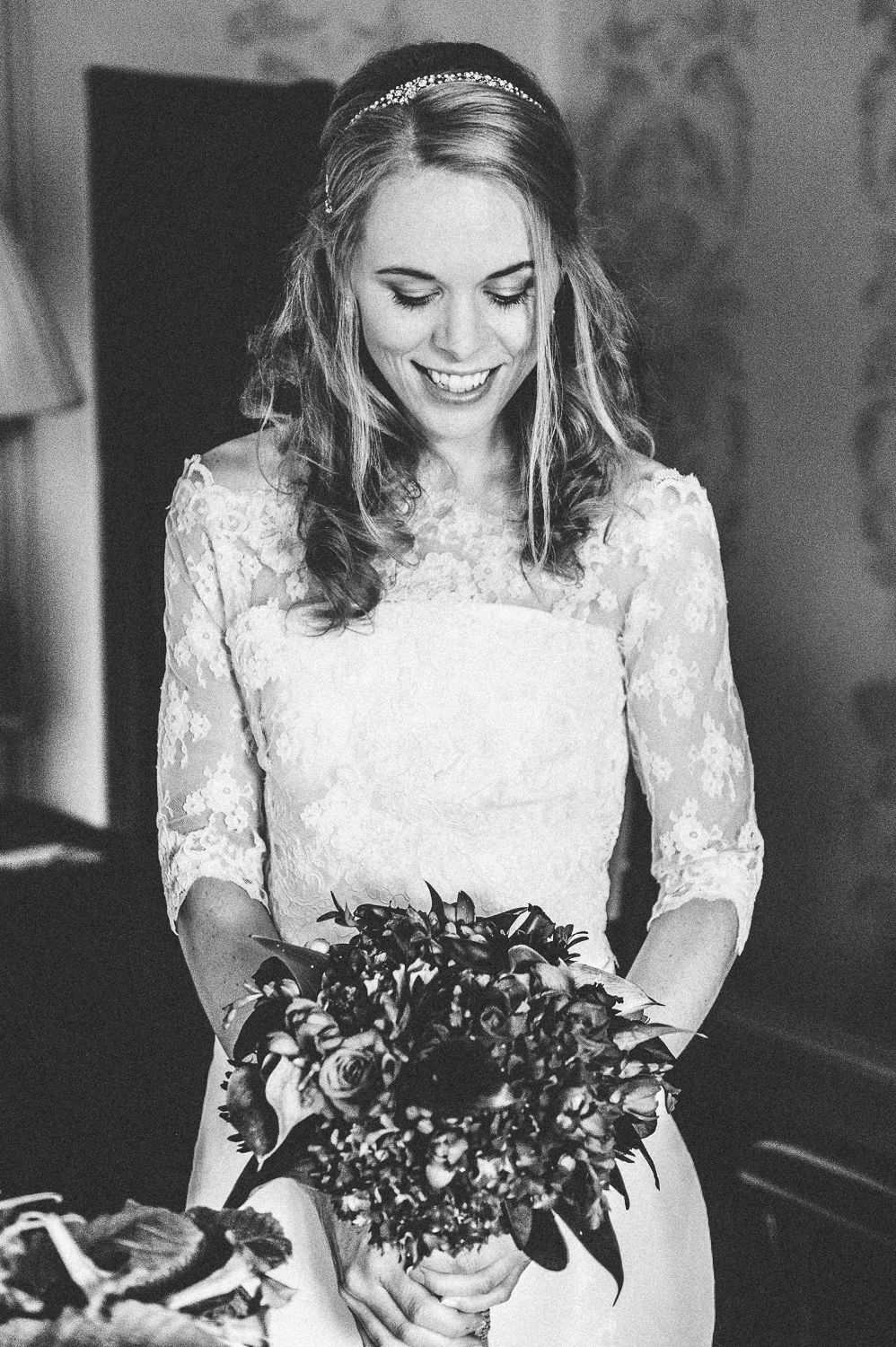 Wedding editorial portrait of bride admiring her bouquet