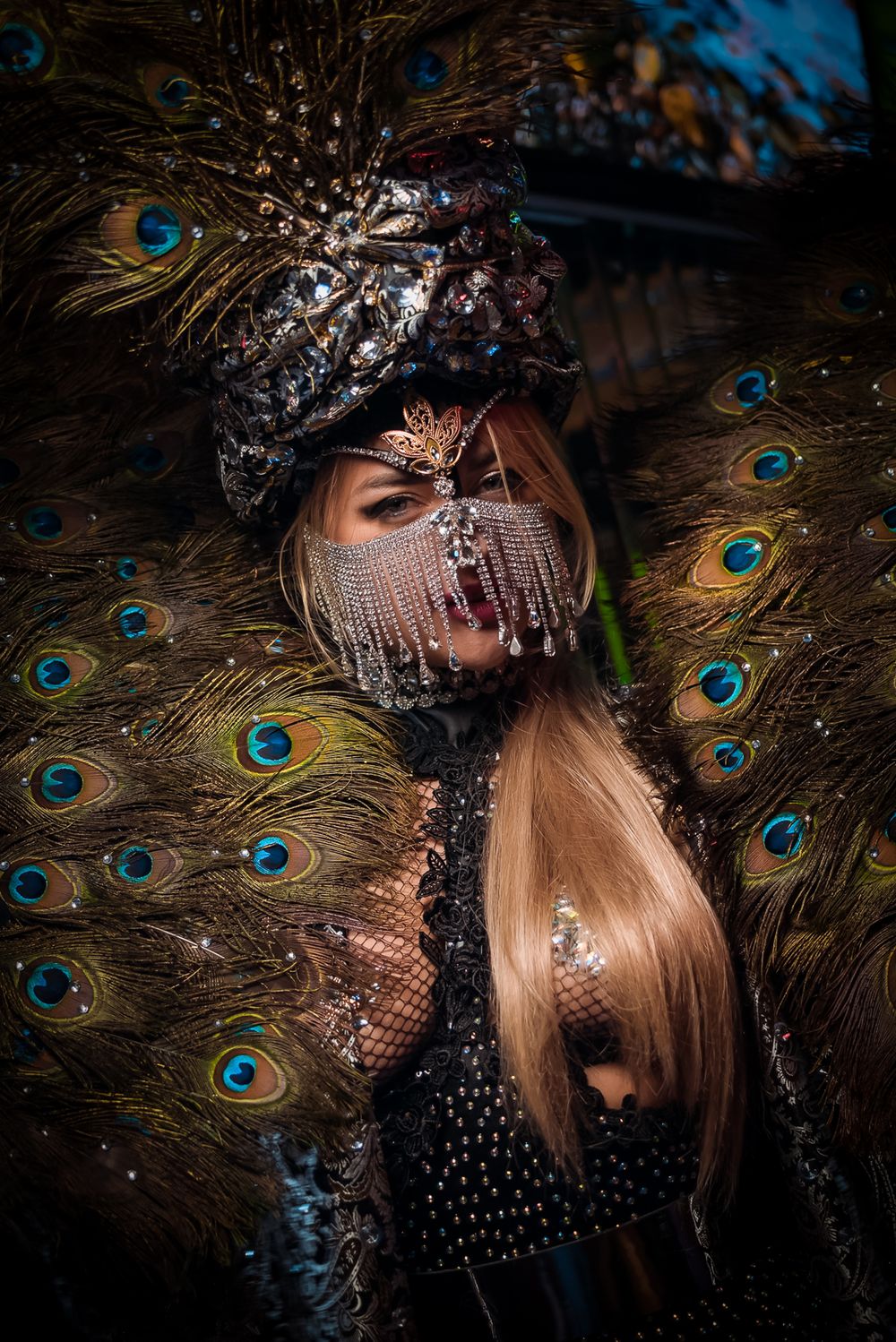 Artistic close-up of peacock feathers and sparkly accessories creating an elegant composition.