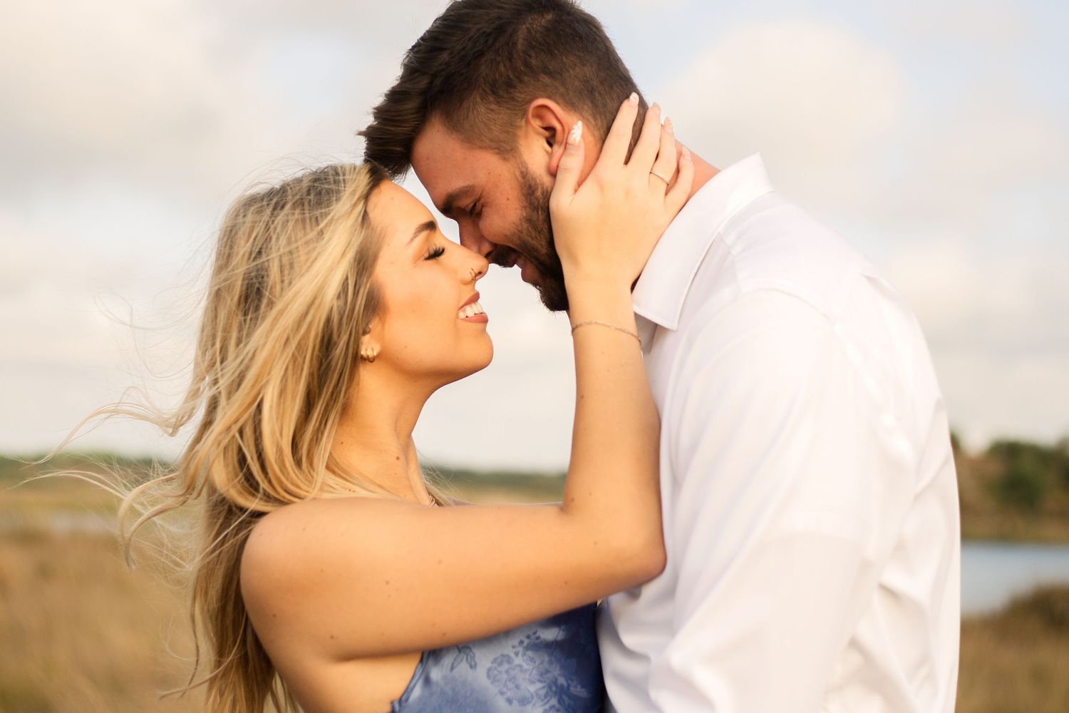 Intimate close-up of couple sharing tender moment in golden evening light.