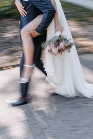 Motion-blur photo of wedding couple's legs and dress during a dance move.