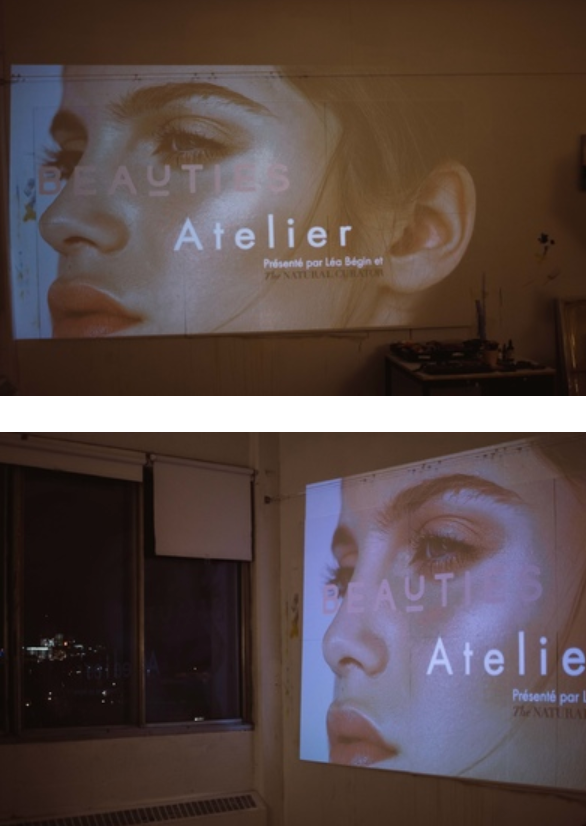 A projected beauty advertisement showing an artistic close-up profile against a dark wall.