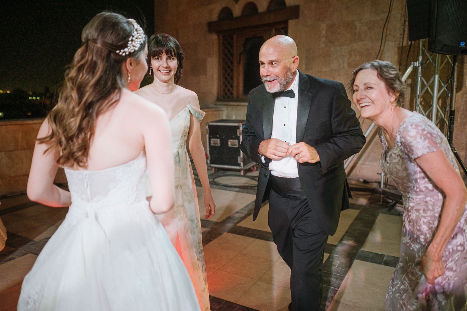 A joyous reception celebration inside an ornate Gothic-style venue.