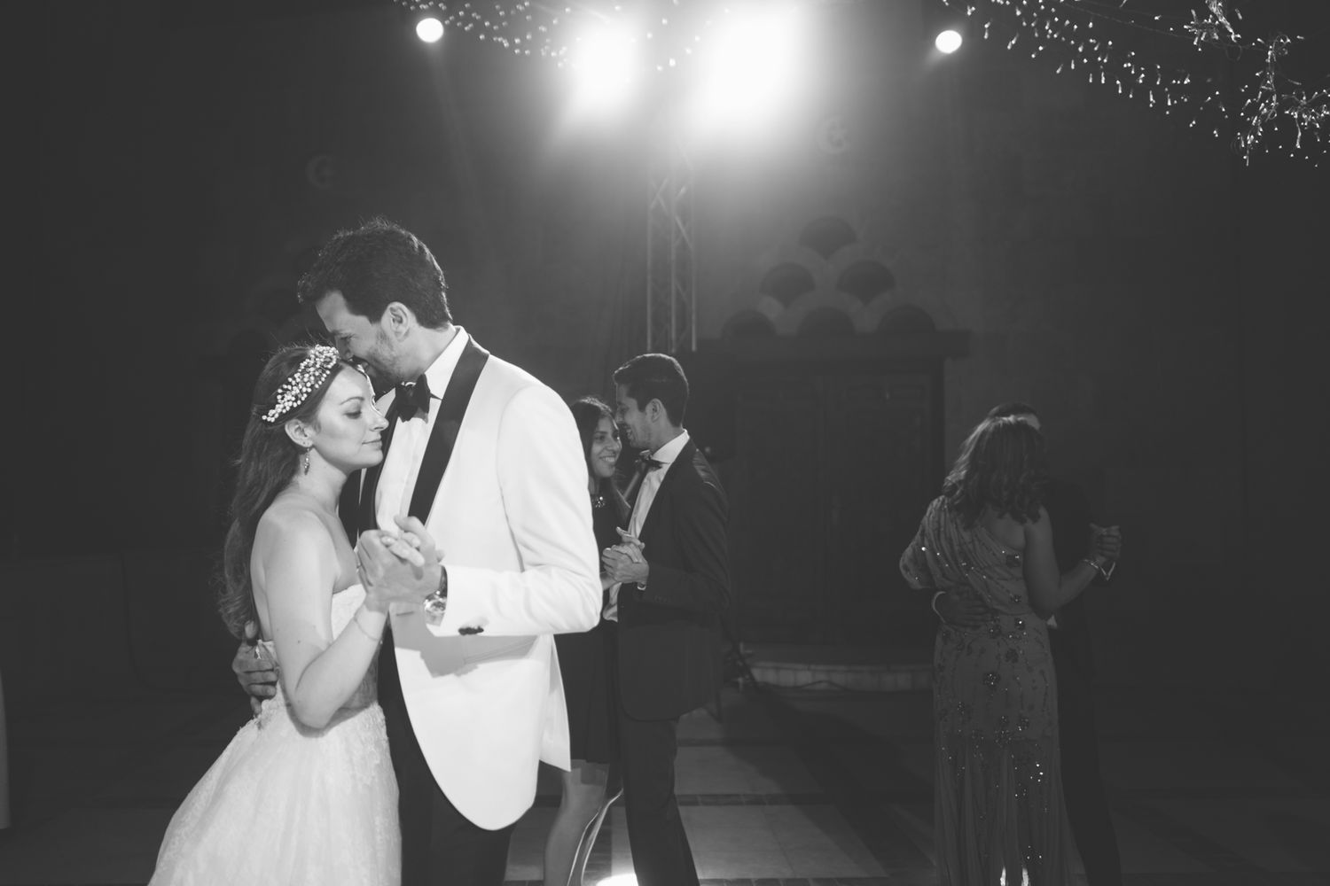 An elegant wedding dance under twinkling lights on a magical evening.