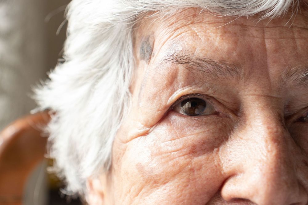 Close up profile showing silver hair and bright lipstick.