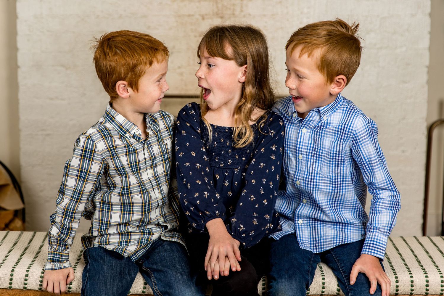 Cute sibling moment, looking at each other and laughing.