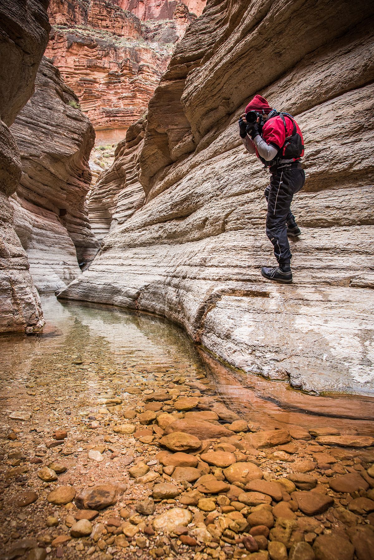 Arkansas nature photographer, Alex Kent poses with camera facing the viewer in a slot canyon along side the Grand Canyon