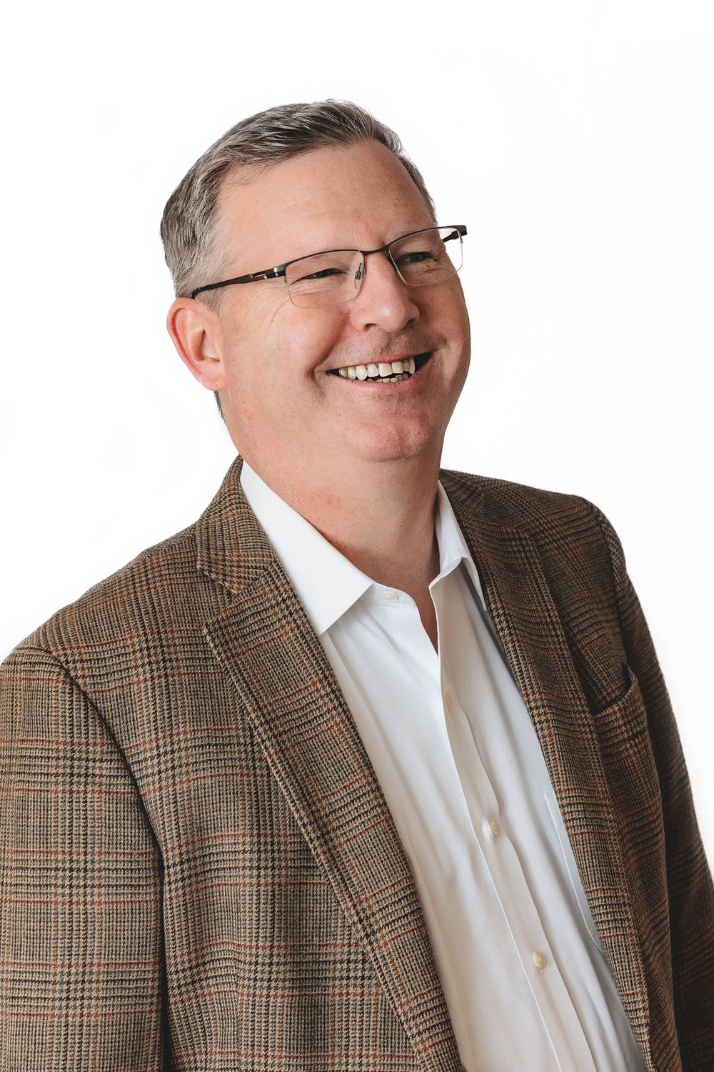 Professional portrait in plaid sport coat and white dress shirt.