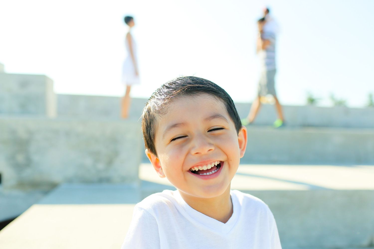 A series of joyful moments captured at a colorful outdoor wall mural location.