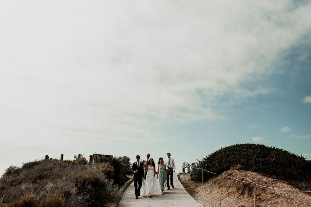 bridal party walking down to crystal cove beach