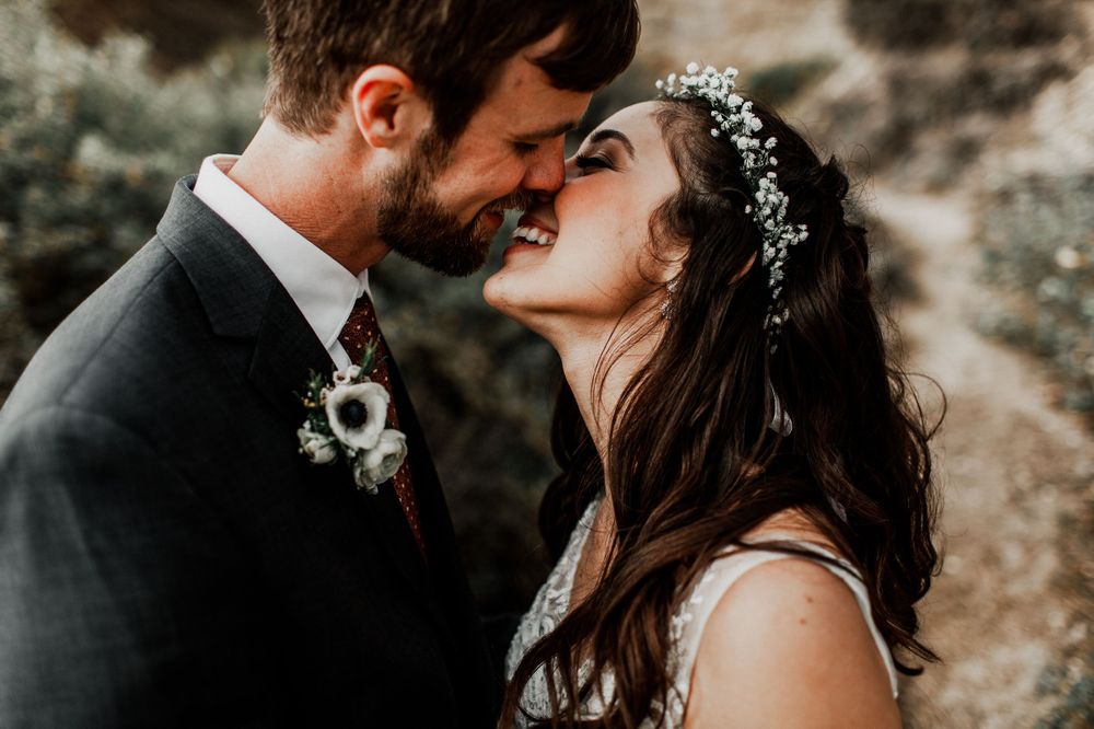 kissing each other bride and groom