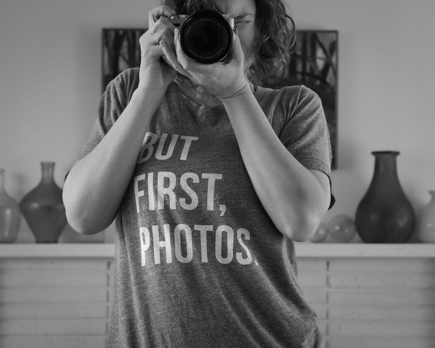 Female photographer holding camera in studio, behind the scenes portrait, North Vancouver