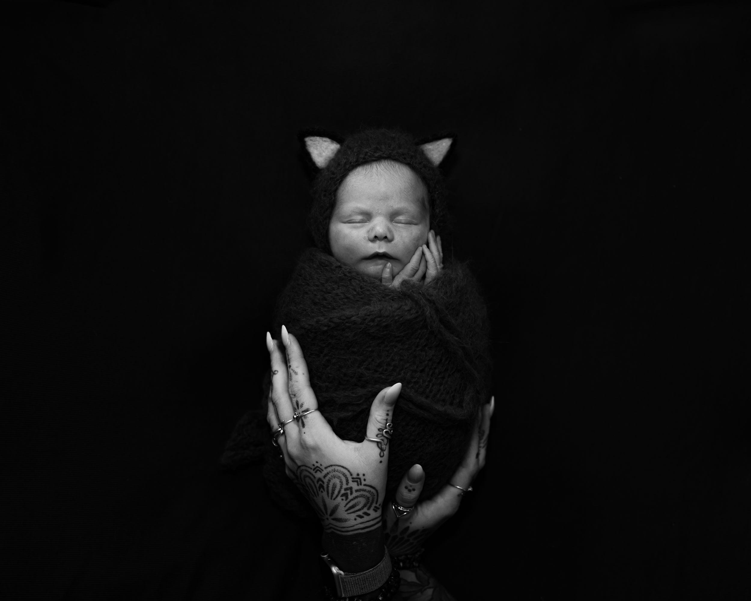 Artistic black and white portrait in dramatic low-key lighting.