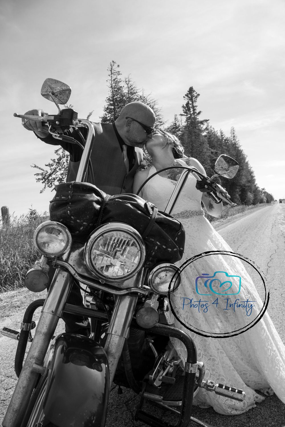 A bride and groom kissing on a motorcycle