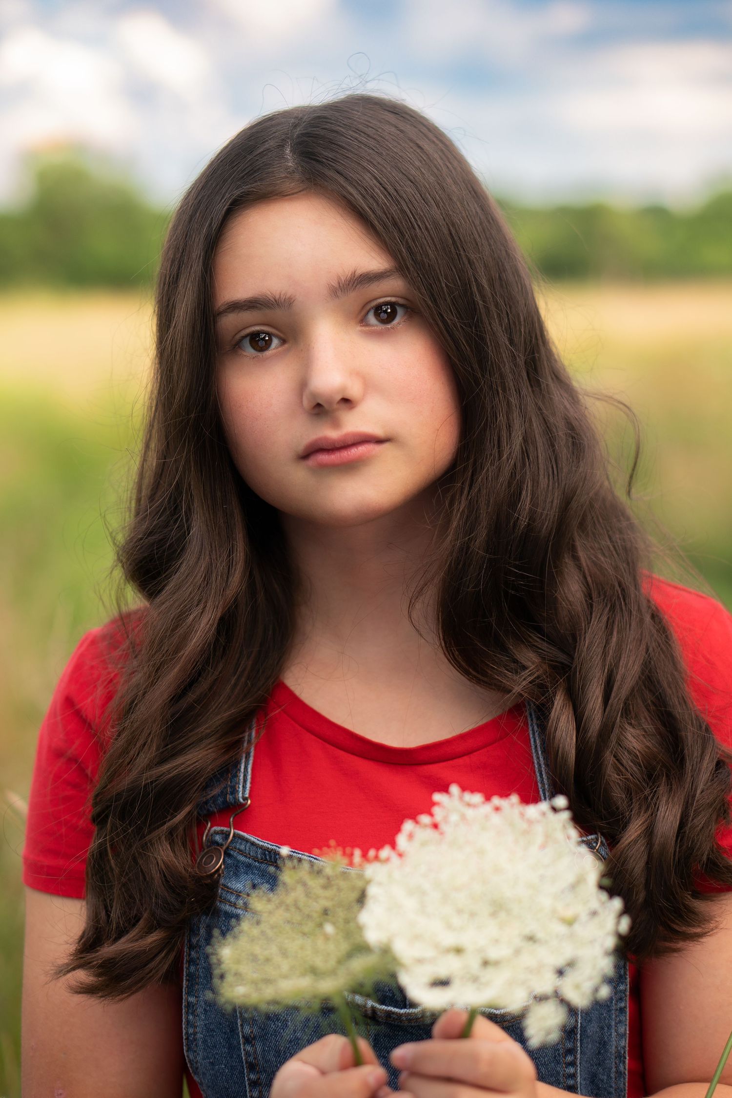 straight-faced teen girl gazes intently at camera