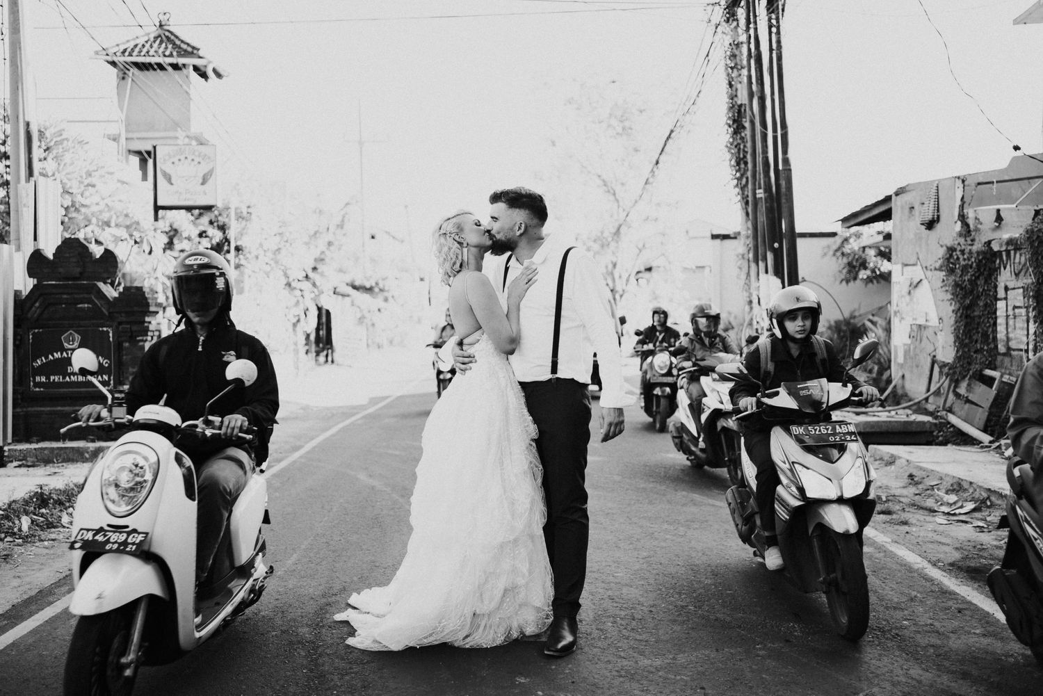 A couple having a kiss in the middle of a traffic road in Canggu, Bali