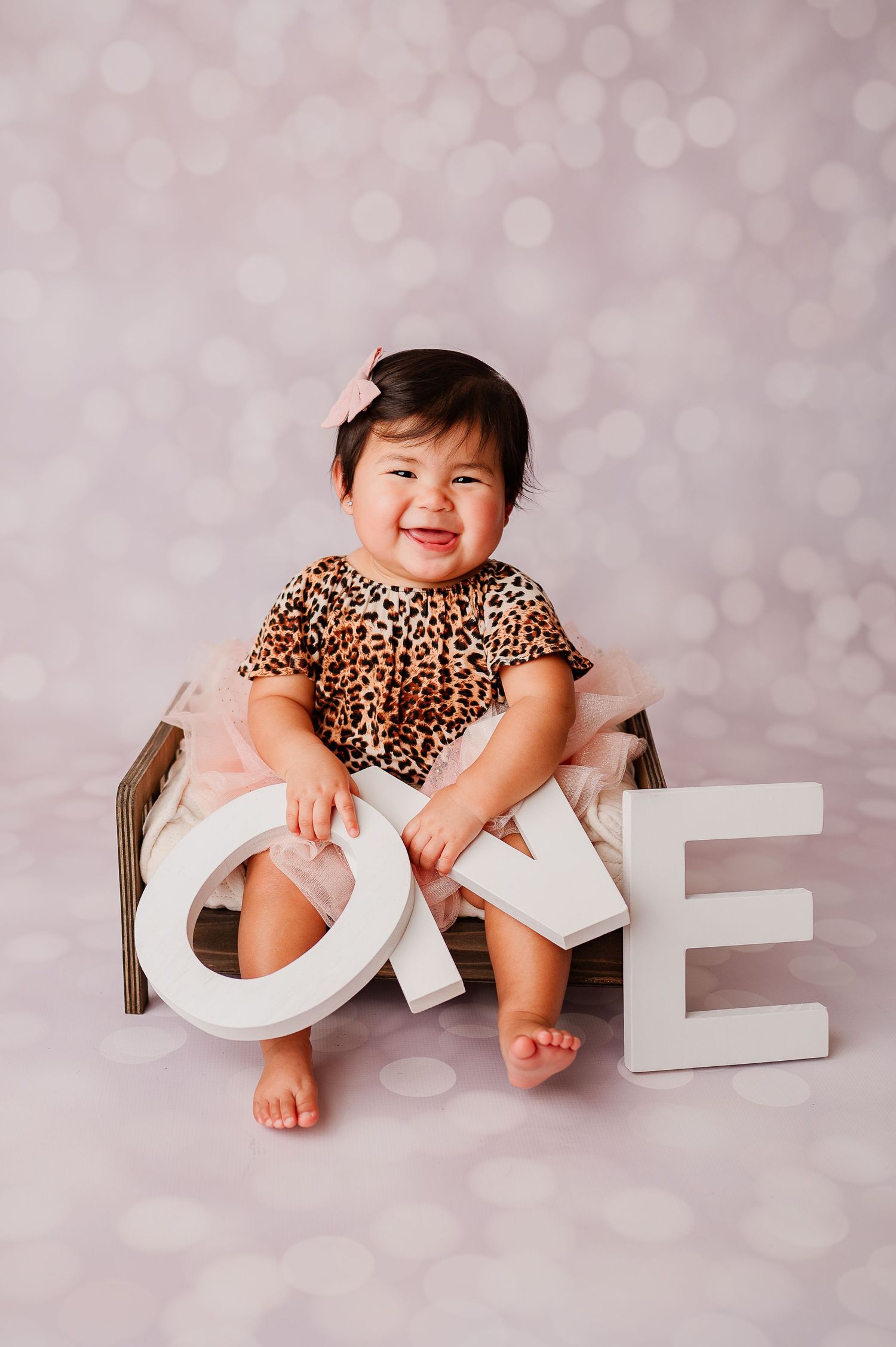 one year old smiling during her studio photoshoot