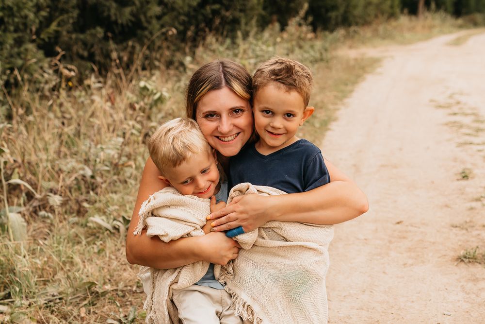 Candid outdoor moment on a country path surrounded by tall grass.