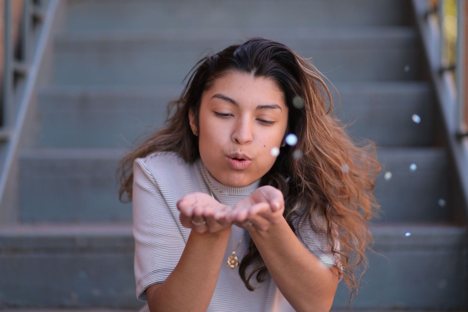 Magical Senior Portrait of a High-school girl blowing Glitter Dust, taken by Larsen Video Marketing and Event Capture