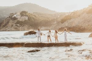 a family stood holding hands in Camp de Mar, Mallorca
