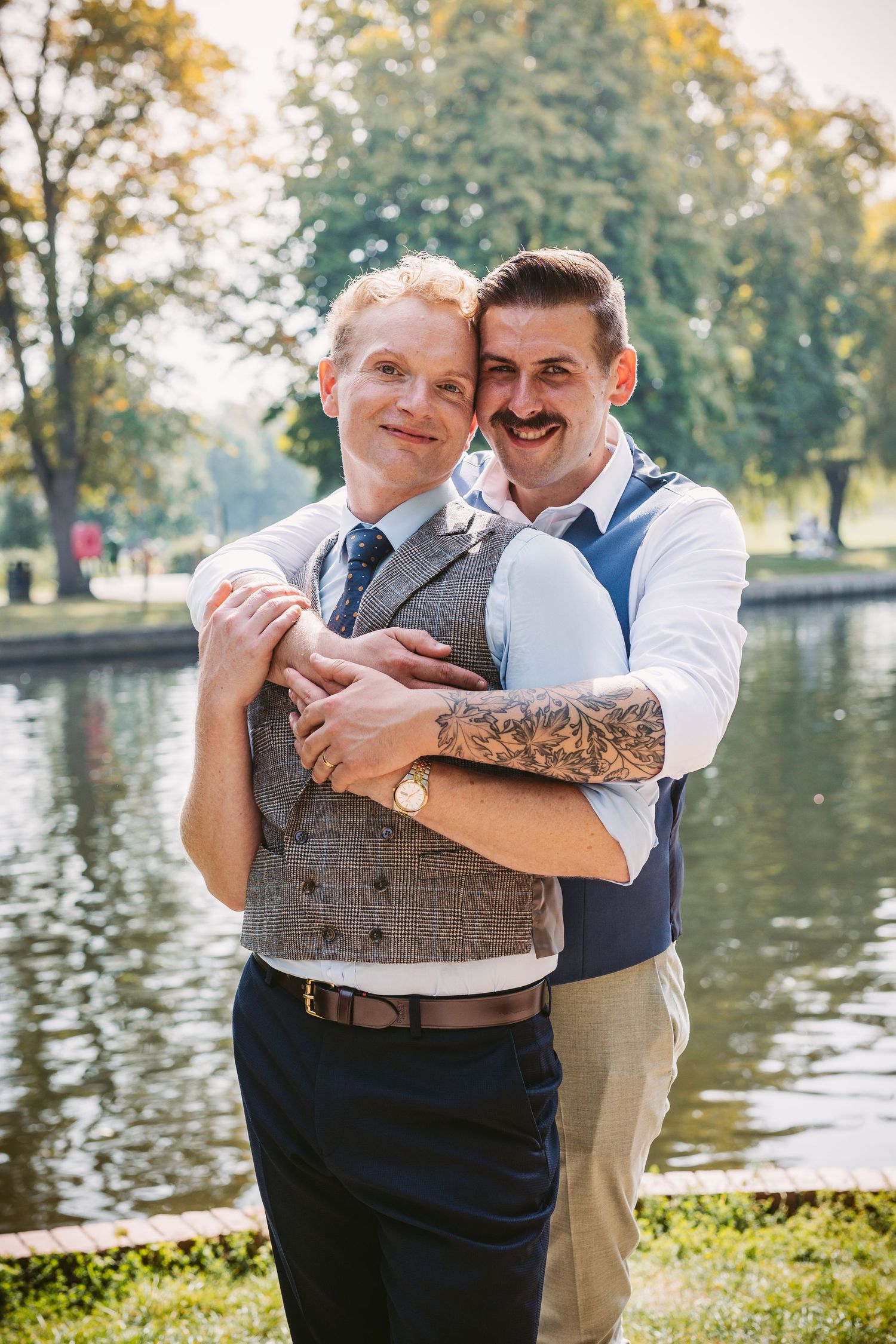 same sex marriage in Stratford Upon Avon newly wed grooms by the river hugging