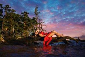 A sequence of sunset photos shows a figure in red floating on dark water against a dramatic purple and orange sky.