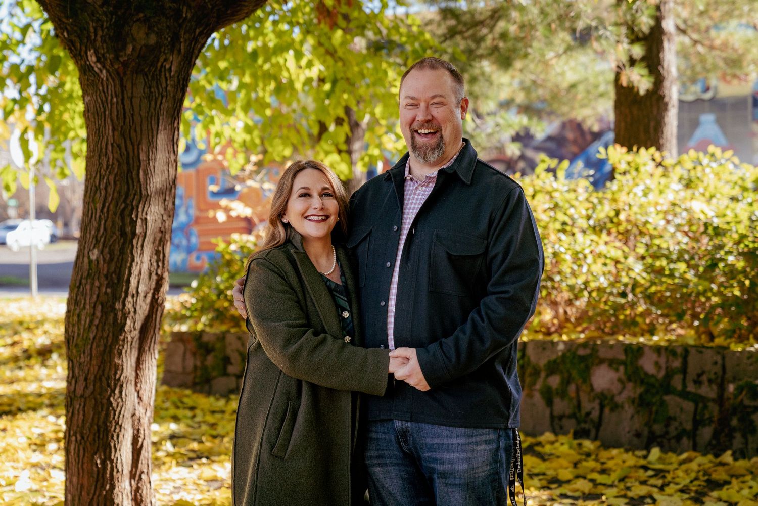 Couple smiling in fall light at local PNW park, Oregon couples session with golden foliage.