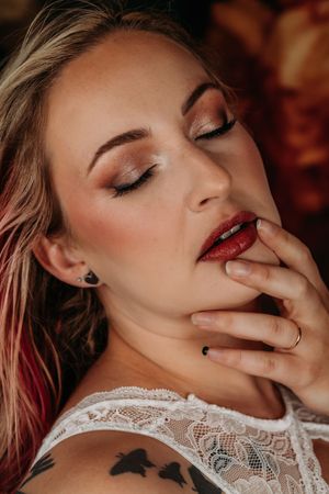 Glamour beauty close up with red lipstick and shimmery eye makeup in moody lighting. Intimate Boudoir Photographer Grand Rapids MI