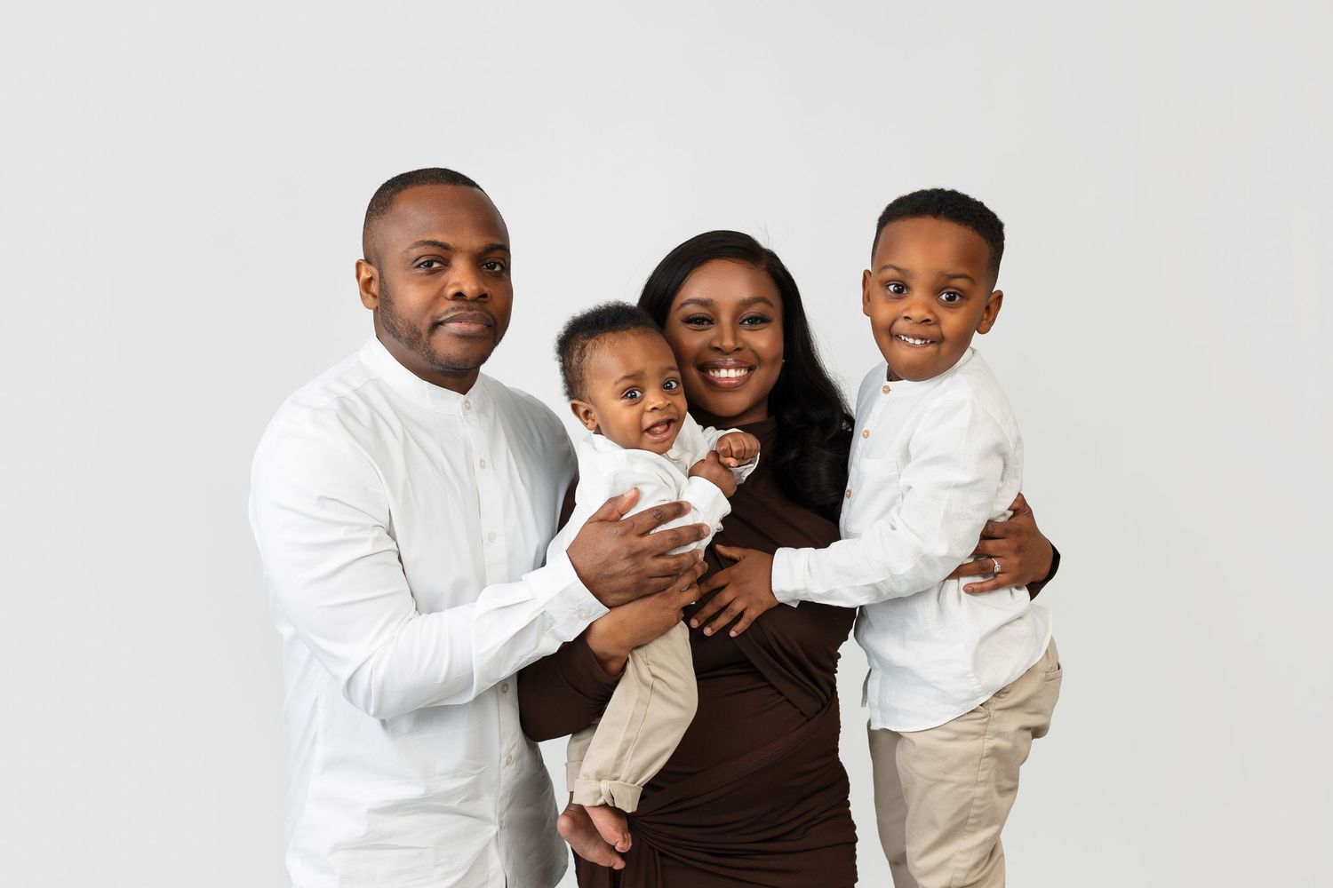 Black and white studio photo collage showing tender family moments with newborn and toddler siblings.