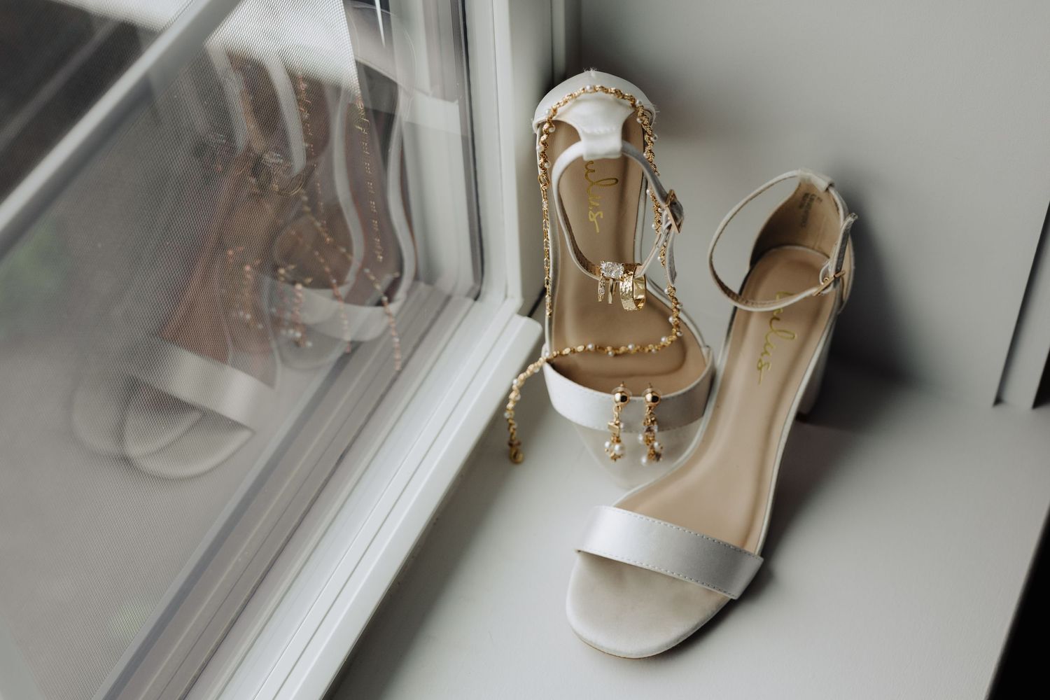 A collection of elegant beige and neutral-toned wedding shoes arranged on a light surface.