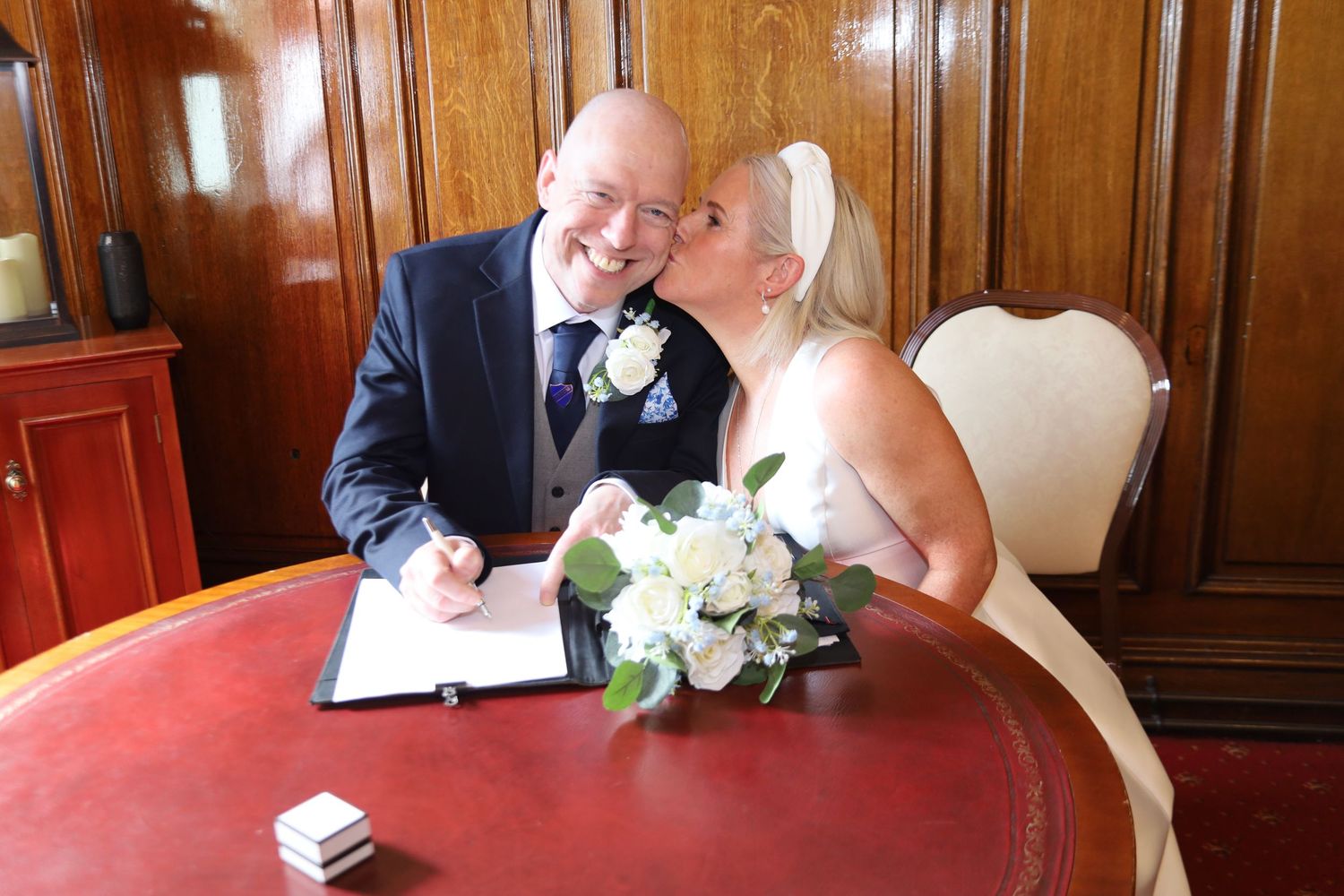 Bride and groom during their wedding ceremony at Stockport Town Hall