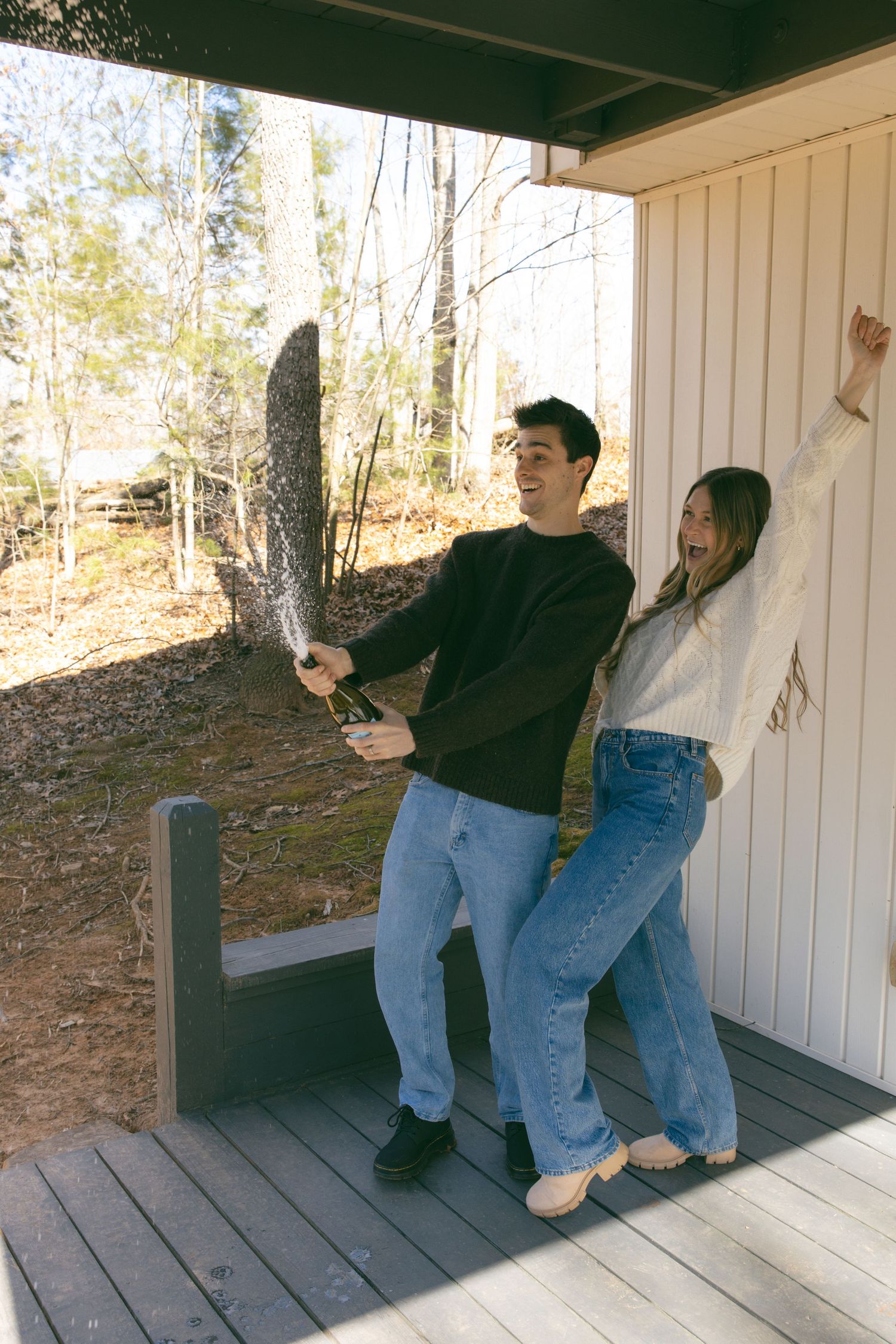 new home asheville photoshoot couples empty house lifestyle session champagne pop celebrating