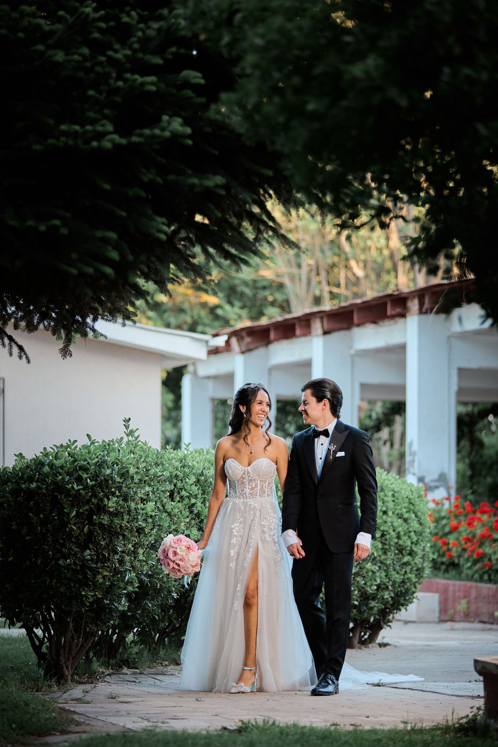 Intimate romantic wedding scene near window showing couple embracing in a rustic cabin setting.