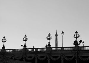 Partial view of Eiffel Tower rising over a bridge