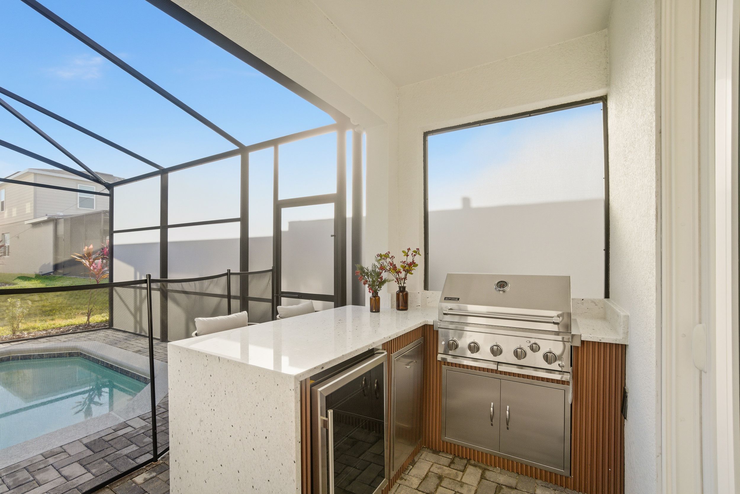 Modern minimalist bathroom interior with glass shower enclosure, white walls, and natural light streaming through windows.