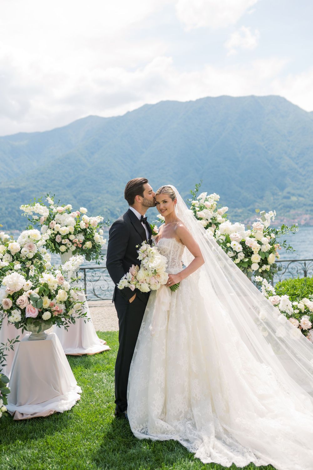 Outdoor wedding celebration with luxurious floral decor and scenic mountain views.