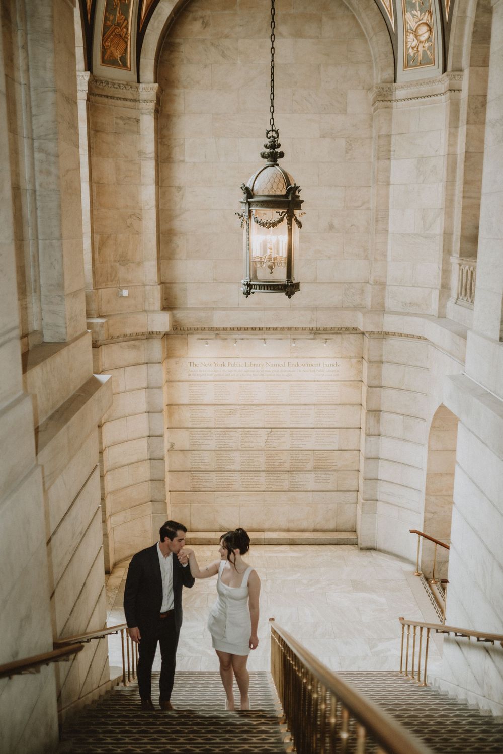 Stone staircase with vintage hanging lantern and arched architectural details.