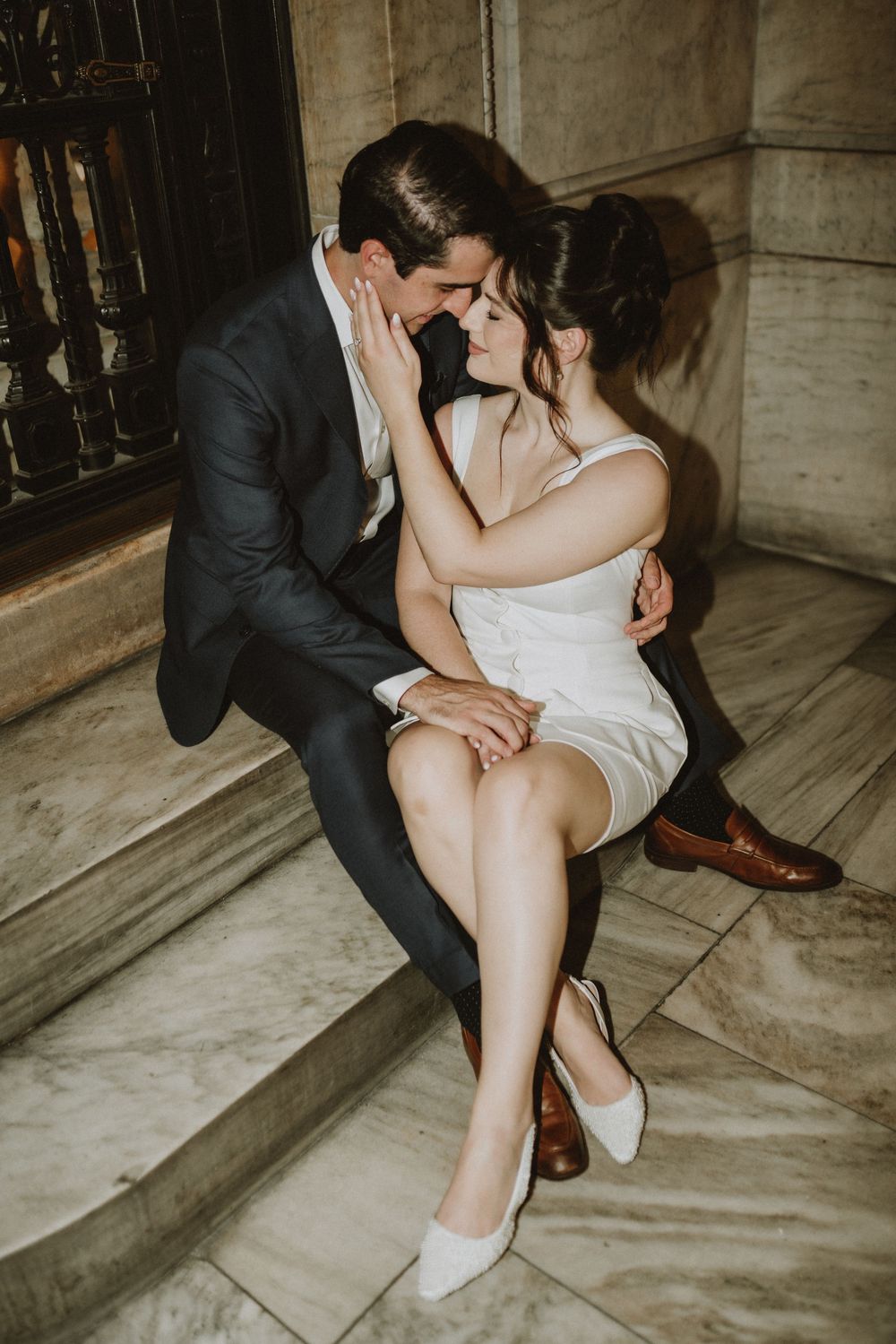 Romantic moment captured on historic stone steps with vintage architectural details.