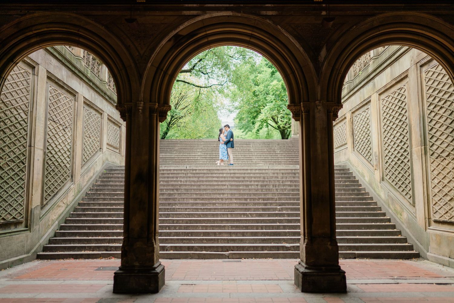 Ornate stone archways and stairs in a historic architectural passageway with decorative details.