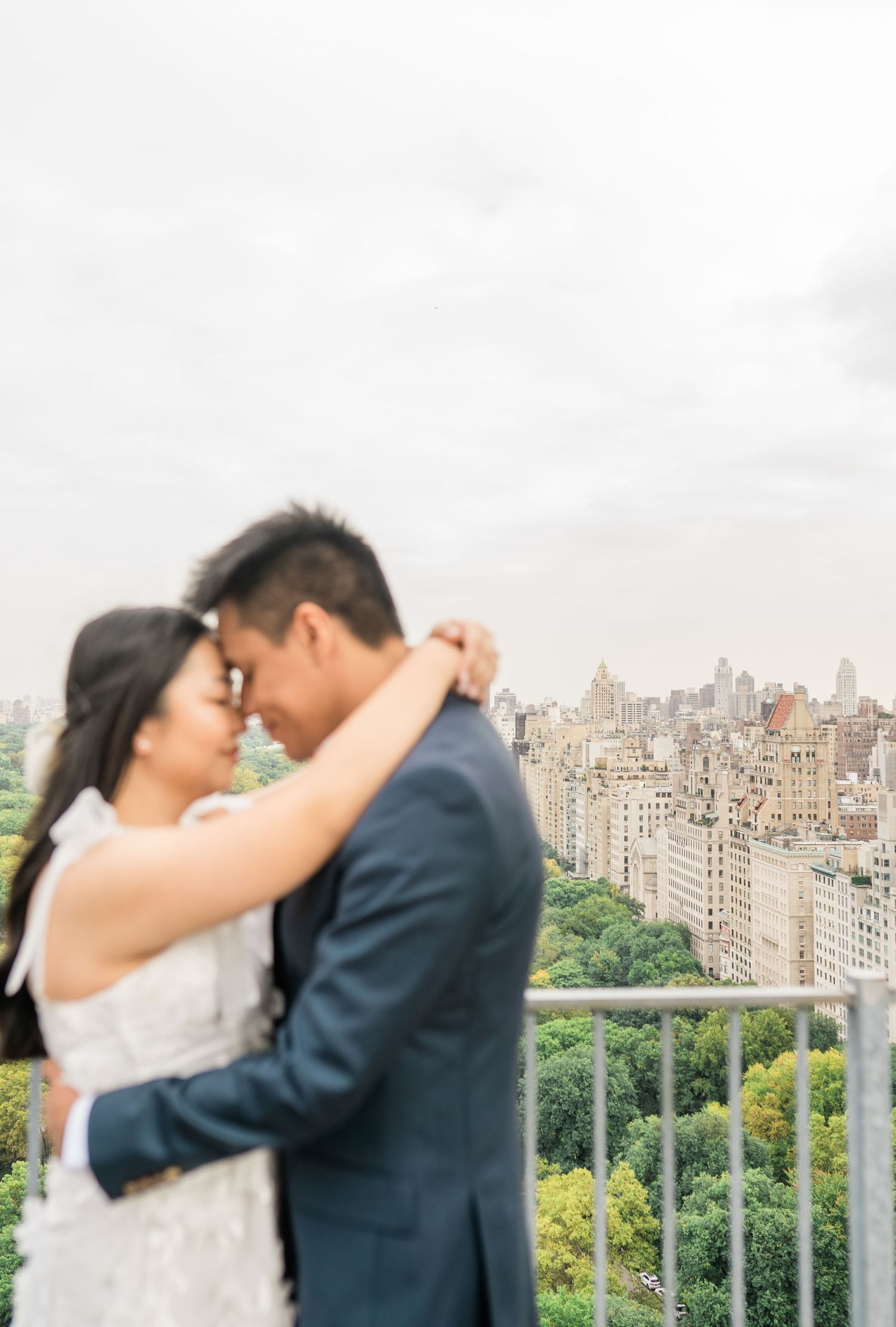 Intimate rooftop portrait with New York City skyline and Central Park views.