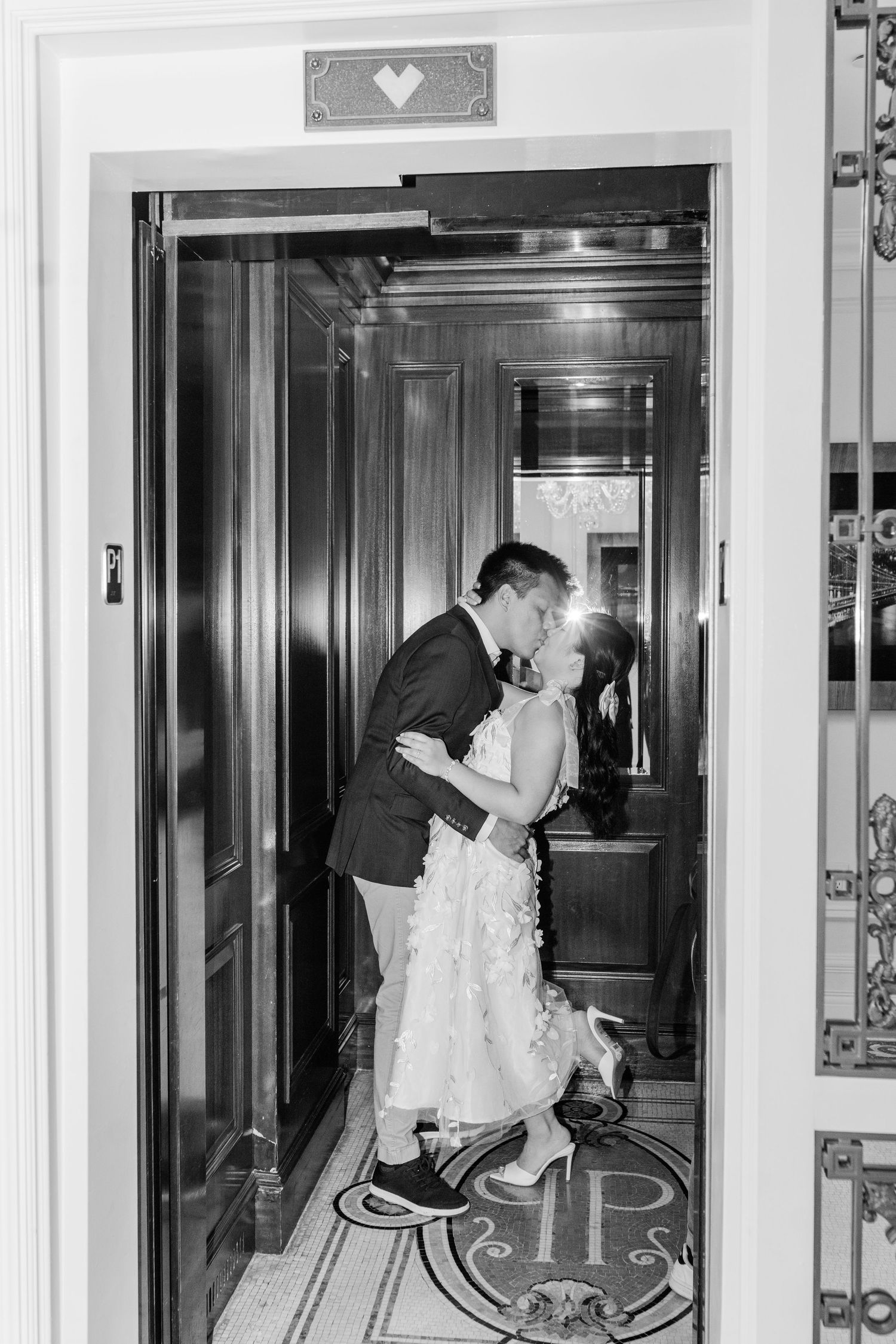 Romantic moment captured in a series of black and white photos inside an elegant elevator.