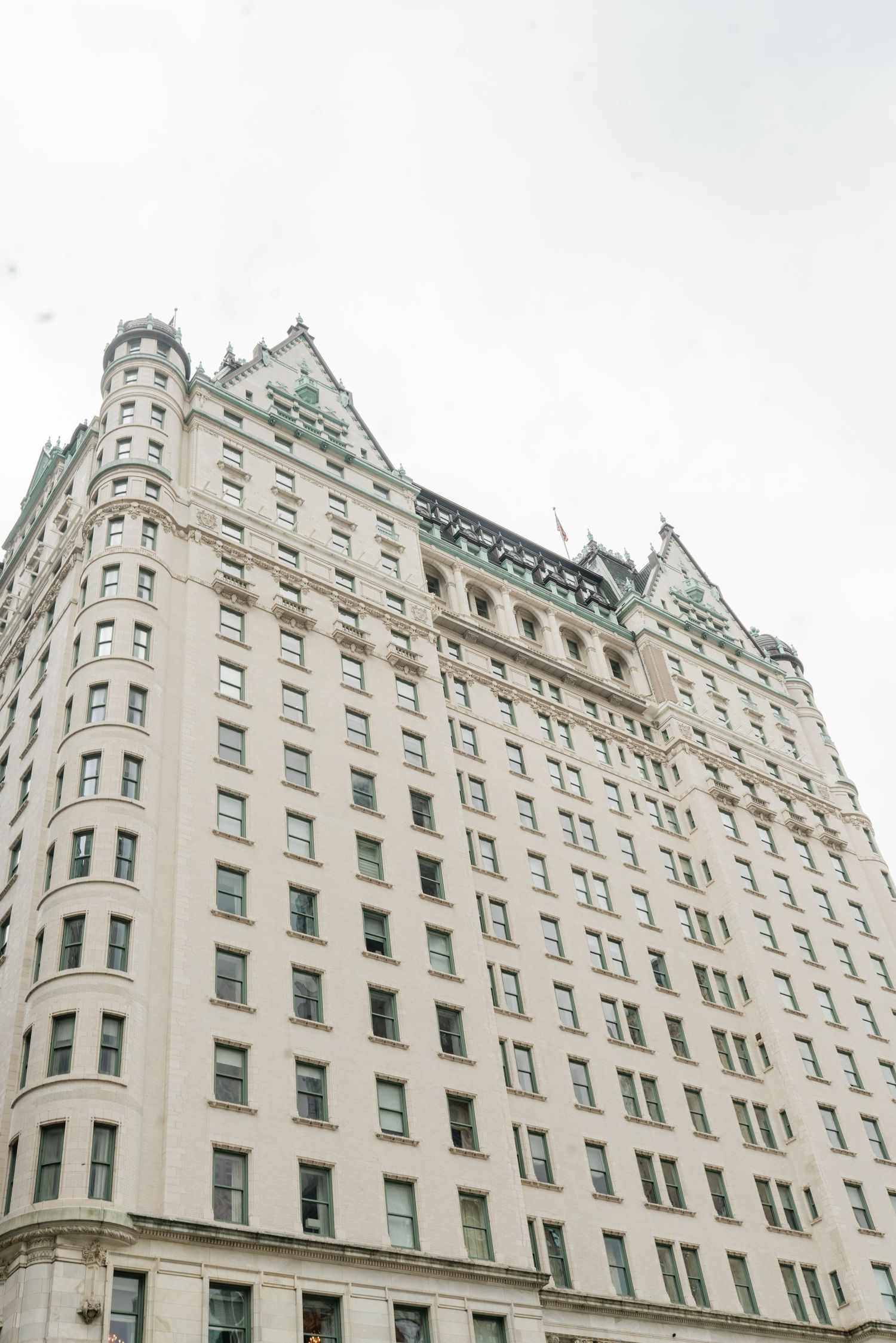 Historic Upper West Side apartment building with ornate architectural details against cloudy sky.