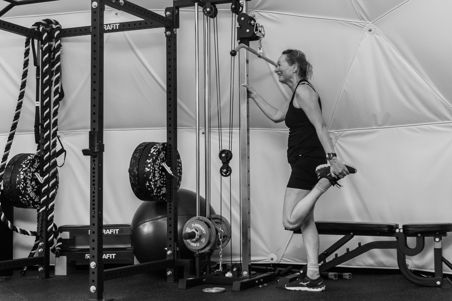 Fitness training sequence showing exercises with resistance bands in gym setting.