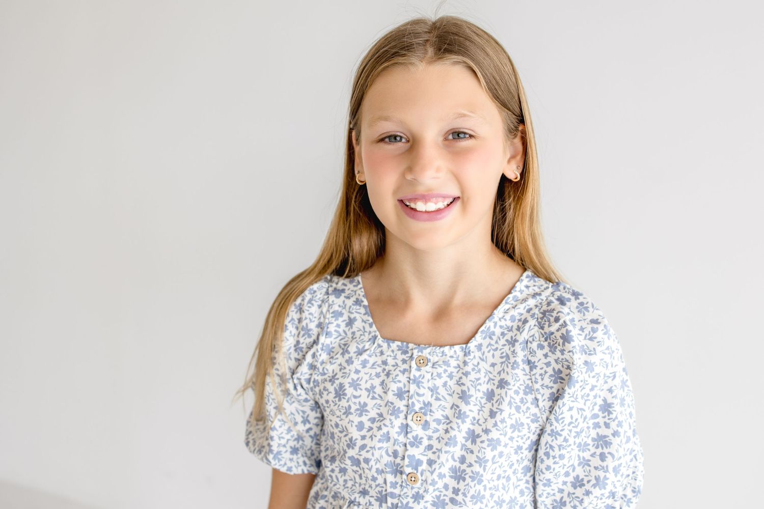 Natural lifestyle portraits featuring floral dress against clean white studio background.