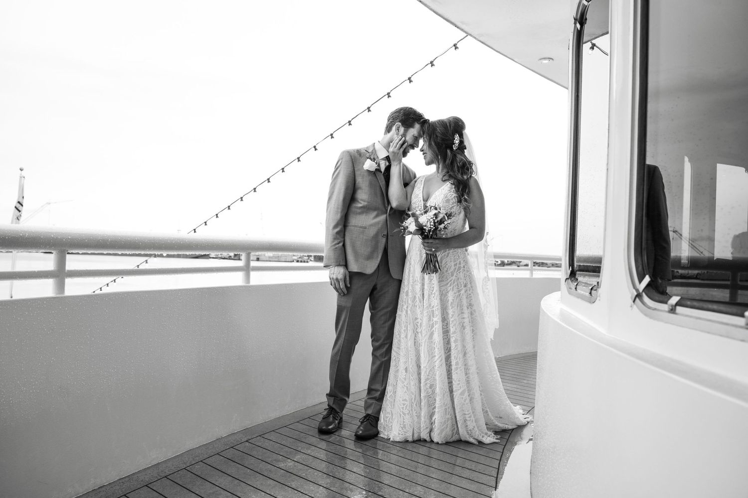Couple shares intimate first look moment before their wedding ceremony in modern rustic venue with barn door.