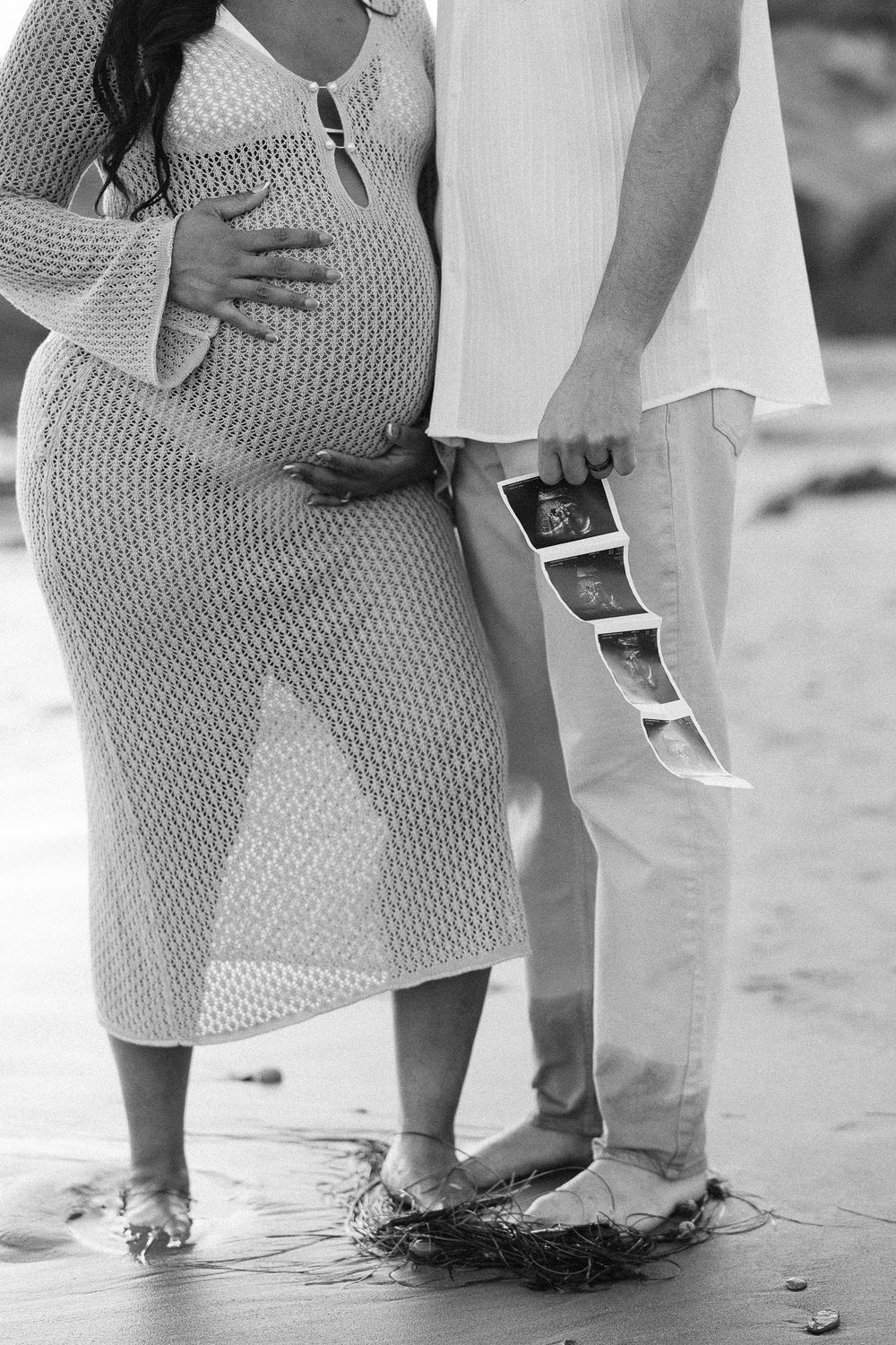Close-up photos of feet dipping in ocean waves on sandy beach in artistic black and white composition.