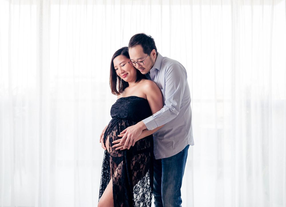 Three candid black and white photographs show intimate emotional moments between two people embracing in a studio setting.